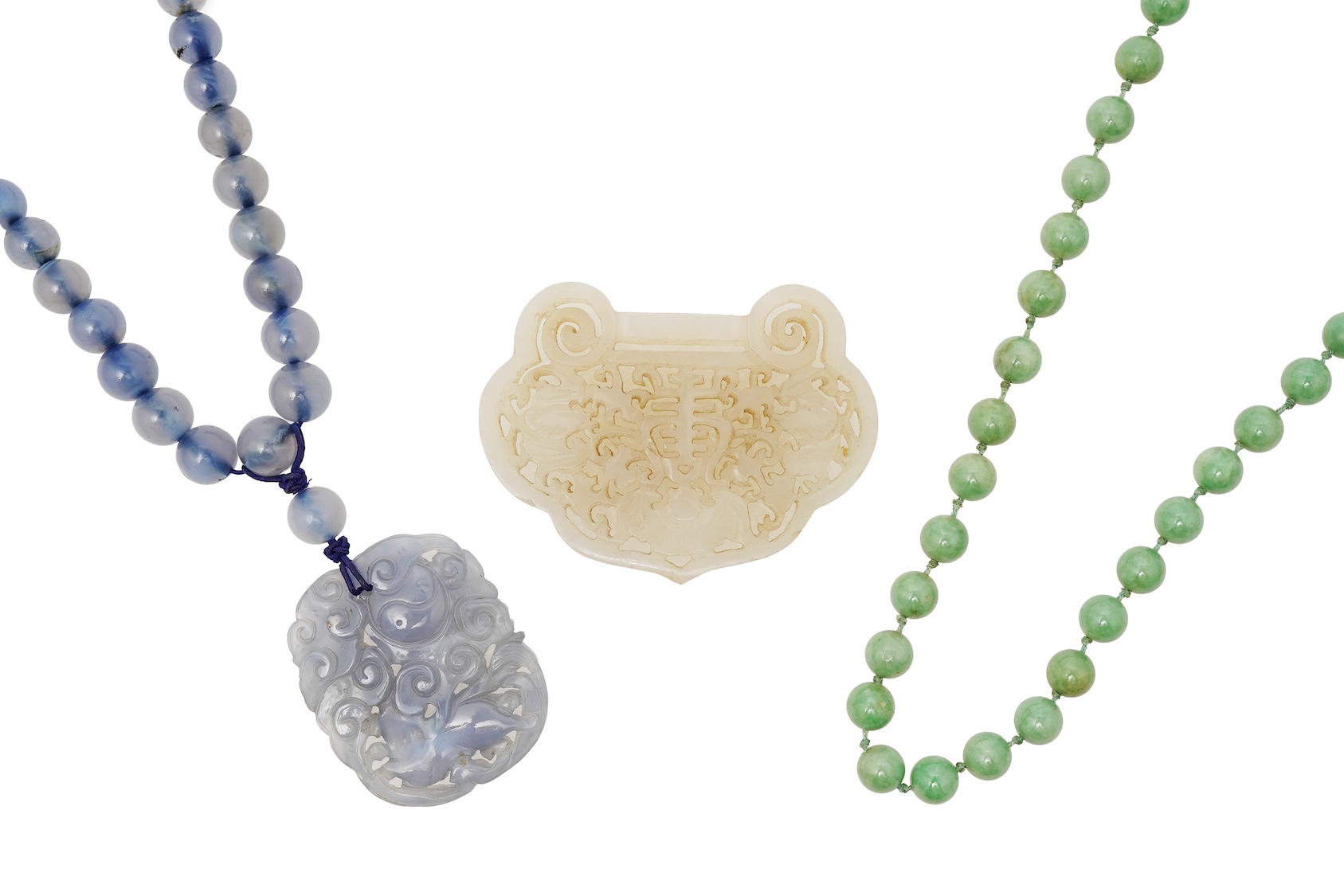 A Chinese jade ‘spirit lock’ plaque, a jadeite bead necklace and a blue quartz bead necklace, 20th century